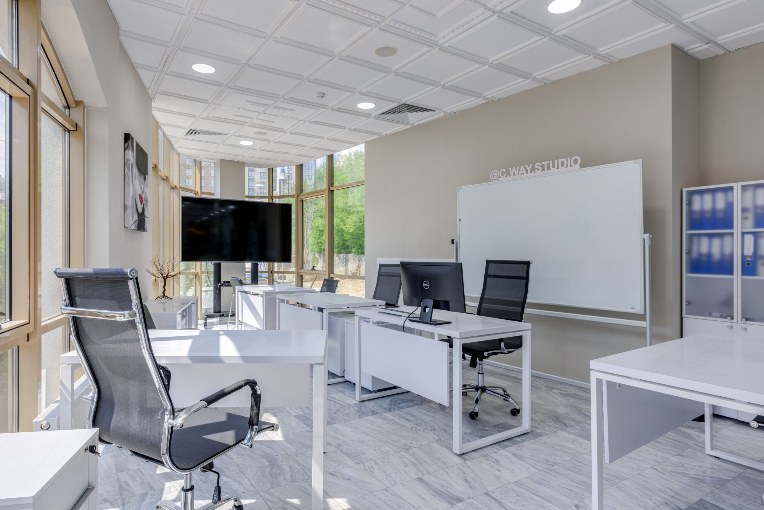Bright contemporary corporate office with clean desks, glass partitions and natural daylight.